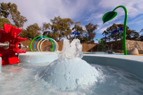 a pool of water with a fountain in the middle of it, Alivio Tourist Park Canberra in Canberra
