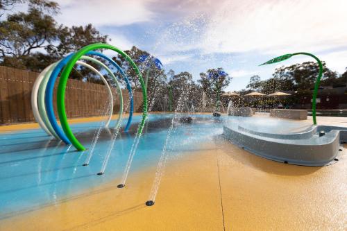 a swimming pool filled with lots of water, Alivio Tourist Park Canberra in Canberra
