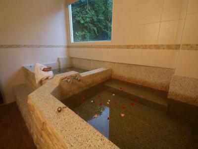 a bath room with a tub and a sink, Victoria Hotspring Resort in Nantou