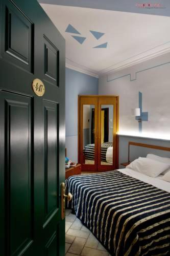 a bedroom with a bed and a dresser, Hotel Villa Degli Angeli in Castel Gandolfo