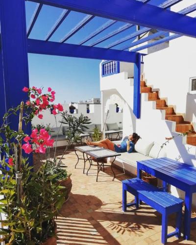 a patio area with a table, chairs, and patio furniture, Riad Haizea Mogador in Essaouira