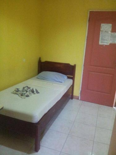 a bedroom with a bed and a door, Eco Pension in Surigao City