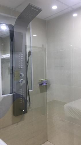 a bathroom with a shower, sink, and toilet, Mai Tuan Pham Hung Hotel in Tay Ninh
