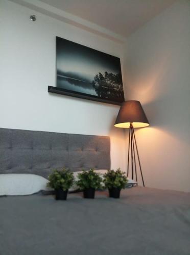 a living room with a lamp and a painting on the wall, Urban Retreat @ Emporis Kota Damansara in Kuala Lumpur