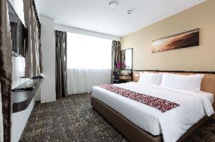 a hotel room with a large bed and a large window, Hotel 7 Suria in Kota Kinabalu