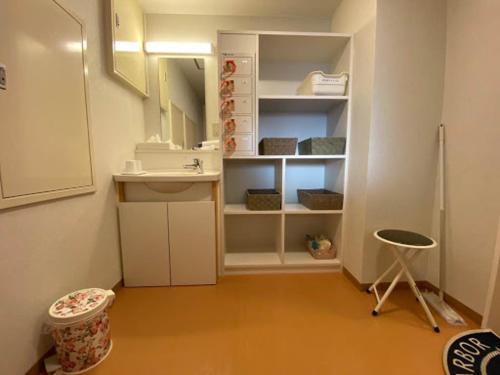 a bathroom with a toilet, sink, and cabinet, Towada City Hotel in Towada