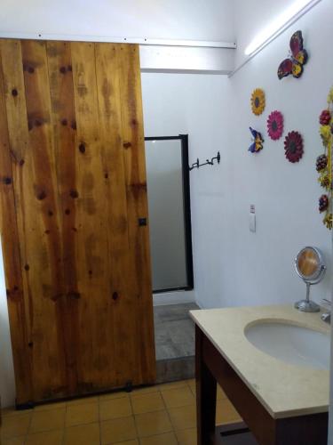 a bathroom with a toilet, sink, and mirror, Casona Tlaquepaque Temazcal & Spa in Guadalajara