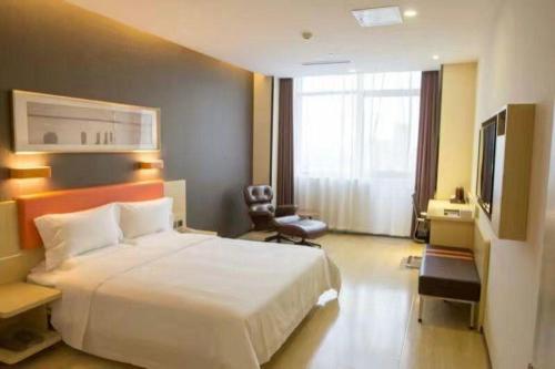 a hotel room with two beds and a television, 7 Days Premium Beijing Fengtai Wumei Market Branch in Beijing
