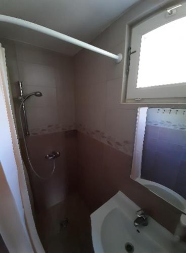 a bathroom with a shower, sink, and toilet, Fortuna Apartmanhazak in Bogacs