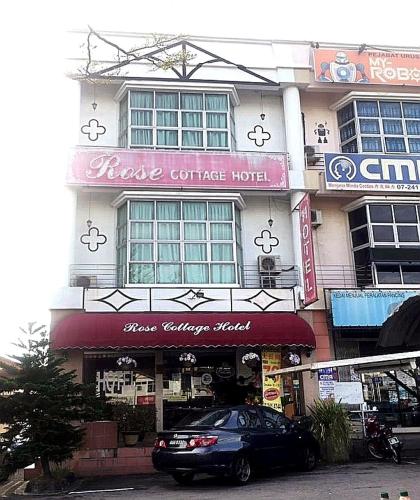 a building with a clock on the front of it, Rose Cottage Hotel Taman Perling in Johor Bahru