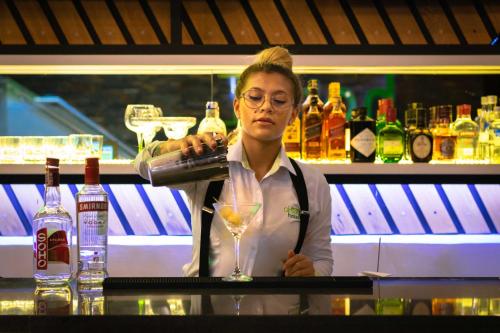 Front View On Wineglass Standing On Bar And Bartender Holding