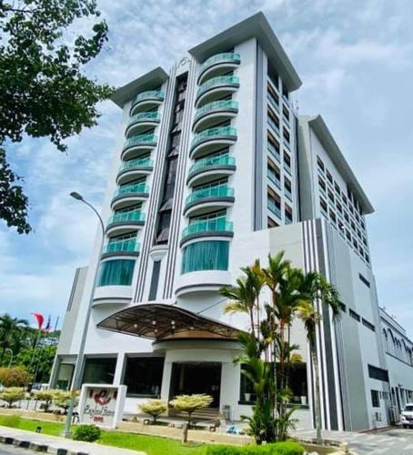 a large building with a clock on the front of it, Langkawi Seaview Hotel in Langkawi
