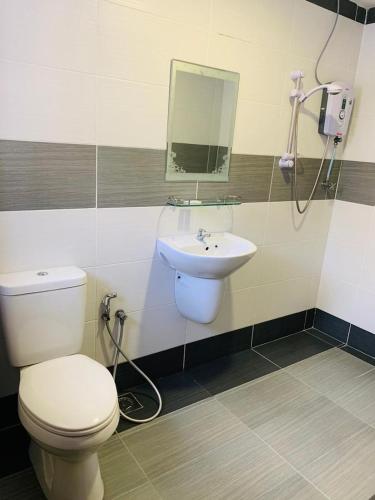 a white toilet sitting next to a sink in a bathroom, Zermatt Hotel in Cameron Highlands