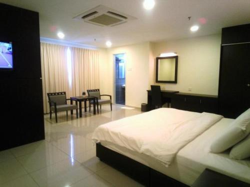 a hotel room with two beds and a television, Villa Hotel in Segamat