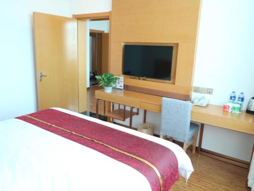 a hotel room with a bed and a television, GreenTree Inn Beijing Huairou District Beifang Town Xingfu Street in Beijing