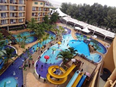a swimming pool filled with lots of colorful umbrellas, Gold Coast Morib International Resort in Banting