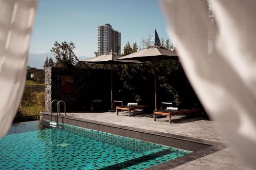 Swimming pool, Brique Hotel Chiang Mai in San Sai
