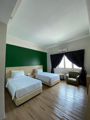 a hotel room with two beds and a desk, Summit Signature Hotel Batu Pahat in Batu Pahat