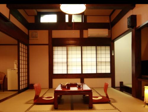 a living room filled with furniture and a large window, Ryokan Murayama in Takayama