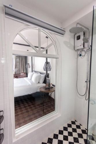 a bathroom with a shower, sink, and mirror, R1 Nimman Hotel Chiangmai in Chiang Mai