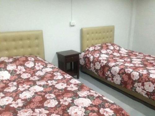 two beds in a room with a white bedspread, Rada Phan in Phan