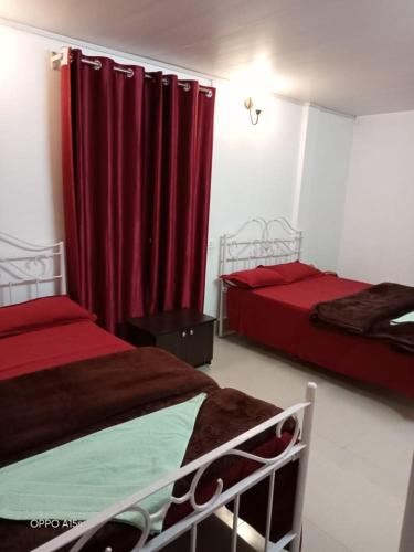 a hotel room with two beds and two lamps, Rani Homestay in Cherrapunji
