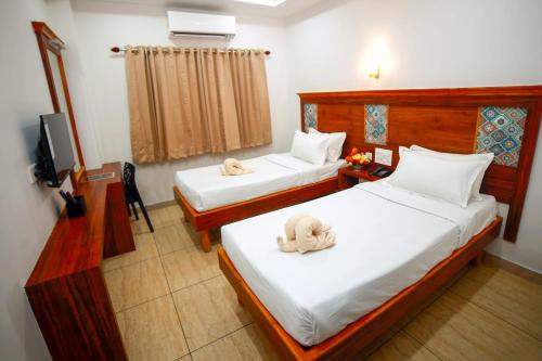 Deluxe Double Room (2 Adults + 1 Child) room in Abi's Residency