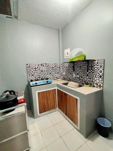 a bathroom with a toilet and a sink, DJCI Apartelle with own Kitchen & Bath 103-212 in Cabanatuan