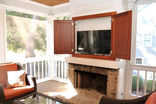 Enjoy our outdoor Tv and screened porch at Marina Cottage