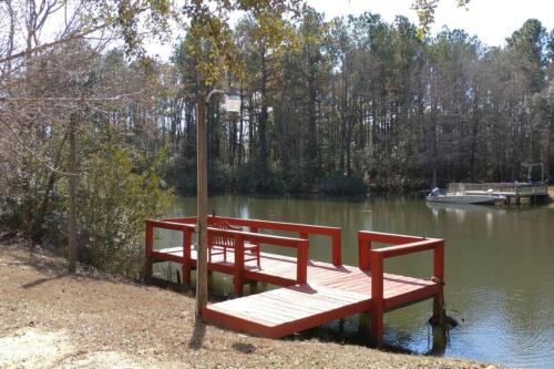 The Lake House at Turtle Cove: Cozy relaxing lake home with dock on wooded lot.