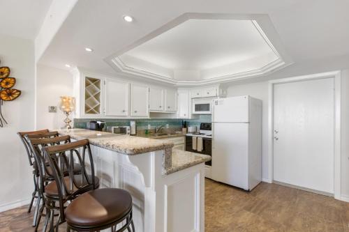 NEW LISTING! Ground floor with spacious patio! Steps to the beach and pool - image 3