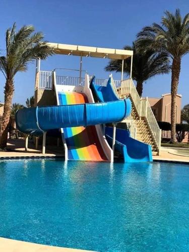 a swimming pool filled with lots of colorful umbrellas, Pyramisa Sunset Pearl Apartments in Hurghada