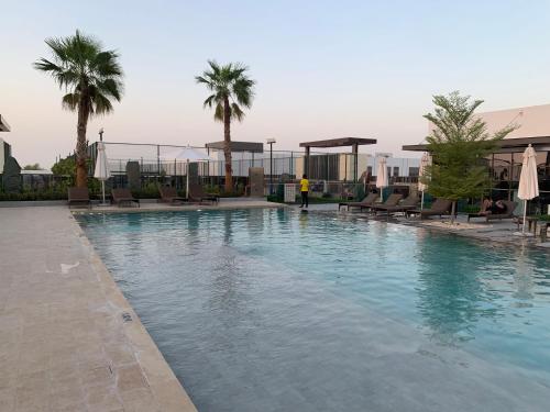 Swimming pool, Opulent 3BR Townhouse at DAMAC Hills 2 Dubailand by Deluxe Holiday Homes in Damac Hills 2