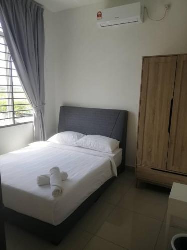 a bedroom with a white bedspread and a white dresser, Johor Desaru Beach Semi-D Bungalow in Desaru