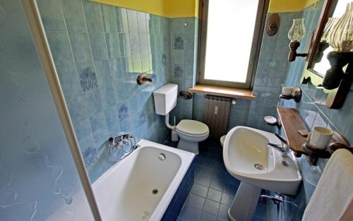 a bathroom with a sink, toilet and bathtub, Champoluc Apartment in Ayas