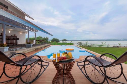 StayVista's Eva Villa - Lakeside Luxury with Modern Decor, Pool & Expansive Lawn - Near Sula