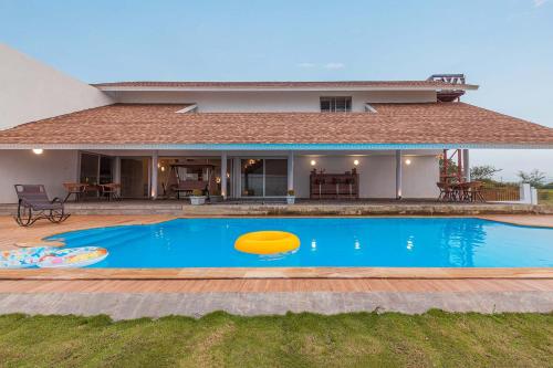 StayVista's Eva Villa - Lakeside Luxury with Modern Decor, Pool & Expansive Lawn - Near Sula