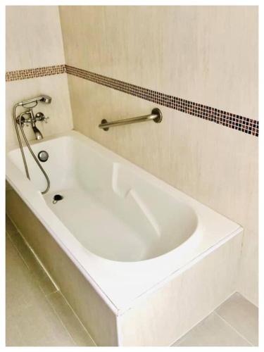 a white bath tub sitting next to a white sink, Lopburi Inn Resort in Lopburi