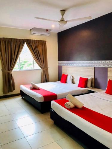 a hotel room with two beds and two lamps, Alia Express Ferringhi in Penang