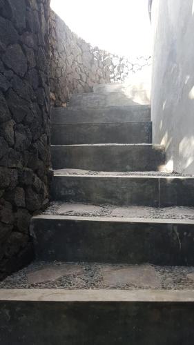 a row of stairs leading up to a stone wall, Geopark Village in Bali
