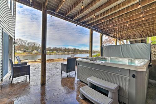 . Lakefront Gladwin Home with Private Beach and Hot Tub