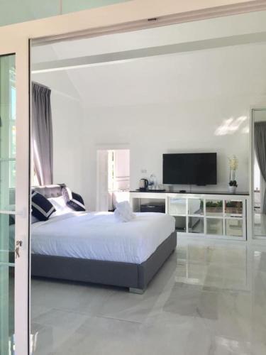 a bedroom with a bed and a television, Mountain View Pool Villa in Nakhon Nayok