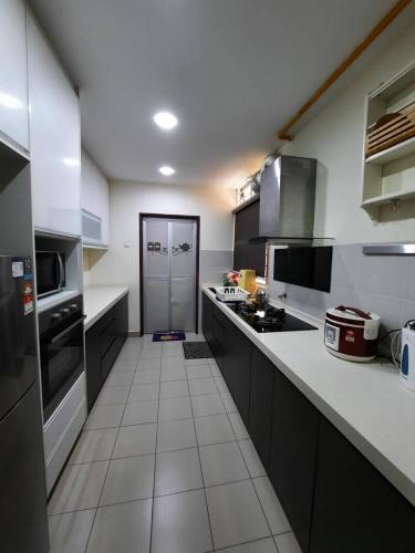 a kitchen with a stove, sink, and refrigerator, HillTree Homestay Putrajaya in Kuala Lumpur