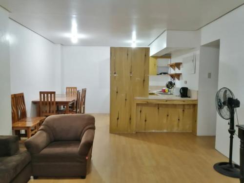 a living room filled with furniture and a kitchen, ELMAR CABIN - The Half House in Baguio