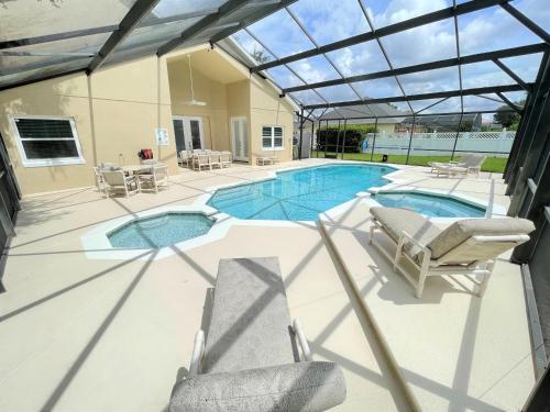 Mickeys Circle - Gorgeous! Modern 6BR, with Private South Facing Pool Hot Tub BBQ Theater 2 Miles to Disney image