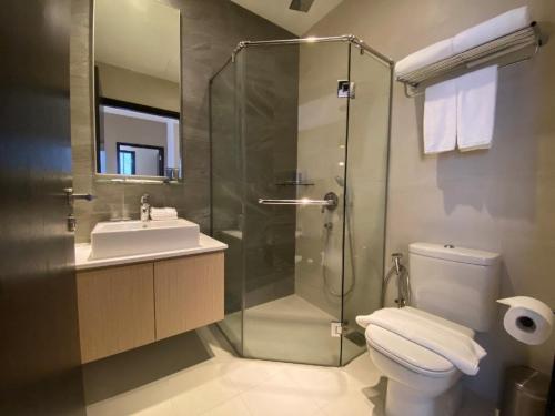 a bathroom with a toilet, sink, and shower, Ariva on Shan Serviced Residences in Singapore