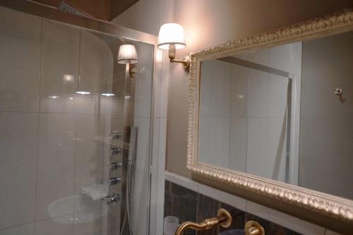 a bathroom with a shower, sink, and mirror, PEPO'S GUESTHOUSE in Nafpaktos