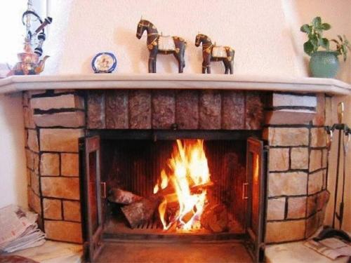 a fireplace that has a fire place in it, Hotel Antigoni in Neochorion