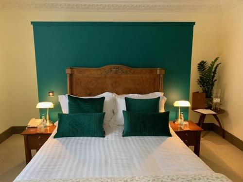 a bed with a white bedspread and pillows, Forest Hotel in Birmingham