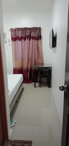 a bathroom with a white curtain and a white toilet, Lei Kendee in Digos
